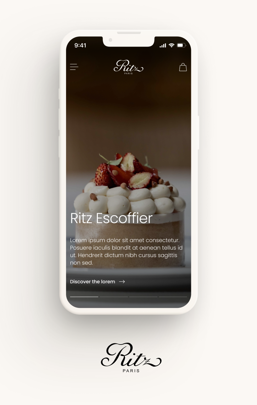 Visuel d’un smartphone affichant la page Ritz Escoffier d’un site ou d’une application du Ritz Paris. L’écran présente une pâtisserie garnie de fraises et de noisettes, le logo Ritz en haut, de la navigation, une icône de panier et un bouton 'Discover the lorem'. Du texte explicatif est partiellement affiché sous le nom Ritz Escoffier.